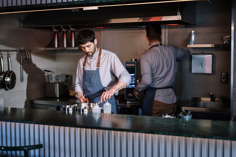 Mod Pizza team members working together in the kitchen